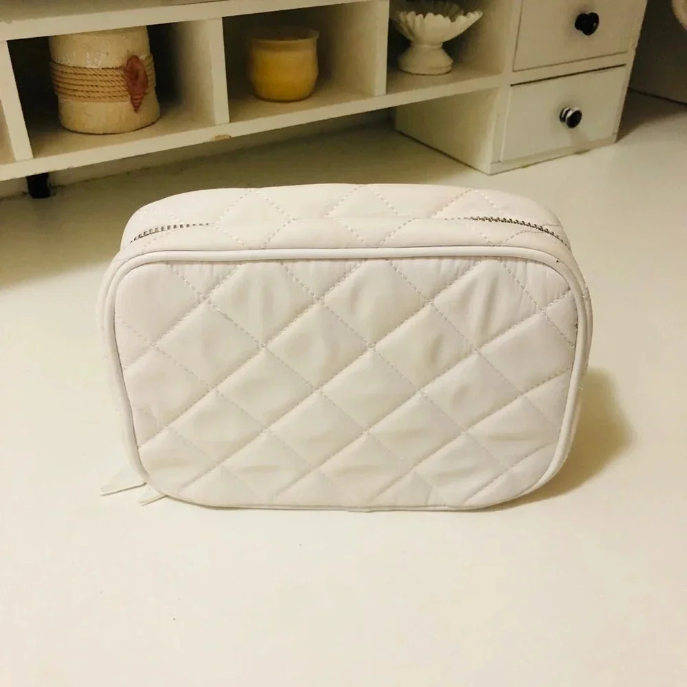 - Trish McEvoy toiletry White quited good conditions bag